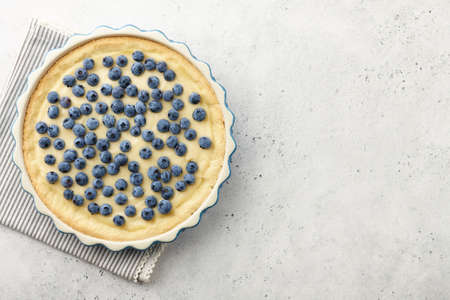 Blueberry pie or tart with fresh berries on white table, copy spaceの写真素材