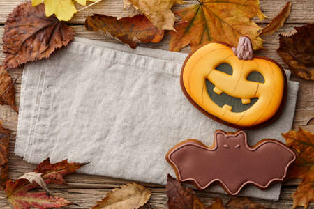 Halloween gingerbread cookies and autumn leaves background, copy spaceの写真素材
