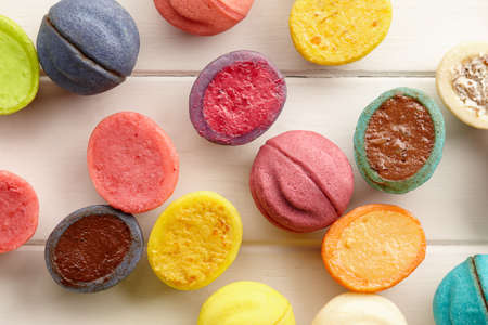 Colorful nut shaped shortbread desserts on white wooden background, close up viewの写真素材