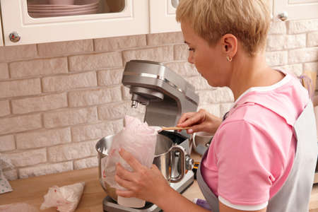Woman confectioner making sweets in the kitchenの写真素材