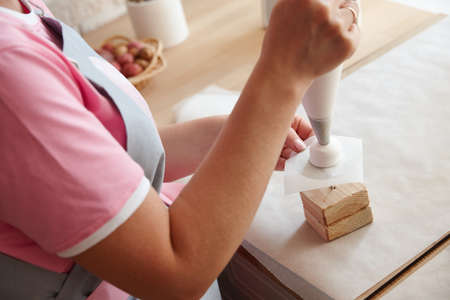 Confectioner making marshmallow desserts with pastry bagの写真素材