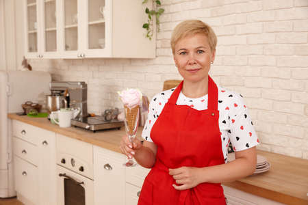 Woman confectioner making marshmallow desserts in kitchenの写真素材