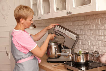 Woman confectioner making sweets in the kitchenの写真素材