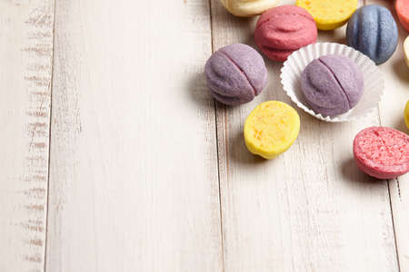 Colorful shortbread desserts on white wooden backgroundの写真素材
