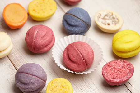 Colorful shortbread desserts on white wooden backgroundの写真素材