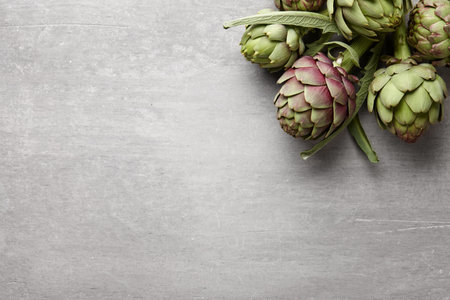 Fresh artichokes on gray concrete background, copy spaceの写真素材