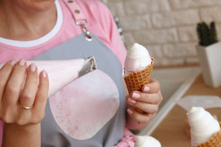 Confectioner making marshmallow ice cream with pastry bag, close up viewの写真素材