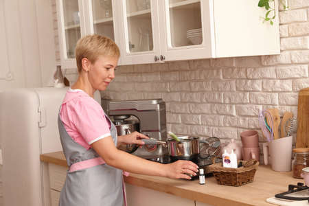 Woman confectioner making sweets in the kitchen. Boiling syrup for marshmallow cream.の写真素材