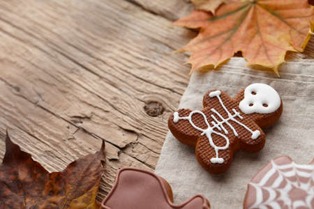 Halloween gingerbread cookies and autumn leaves background, copy spaceの写真素材