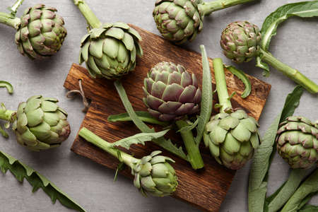 Fresh green artichokes cooking on gray concrete background, top viewの写真素材