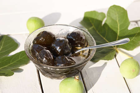 Green fig jam bowl on white wooden tableの写真素材