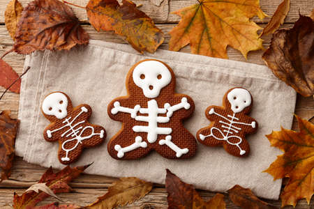 Halloween gingerbread skeleton biscuits and fall leavesの写真素材
