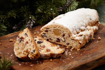 Sliced Christmas stollen cake on wooden boardの写真素材
