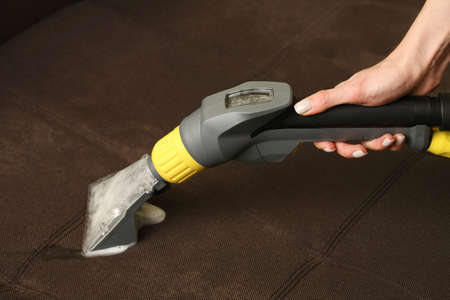 Deep professional cleaning of sofa with vaccum cleanerの写真素材