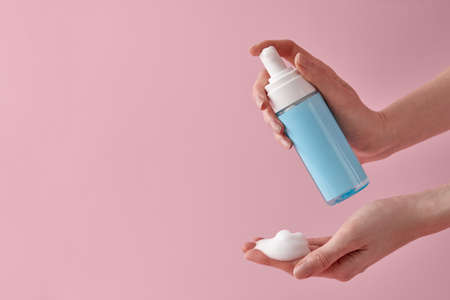 Woman applying cleansing foam to hand close upの写真素材