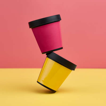 Two plastic containers for cosmetics and body care products