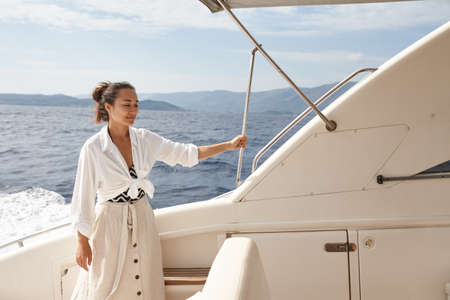 Woman on white yacht in the sea during summer vacationの写真素材