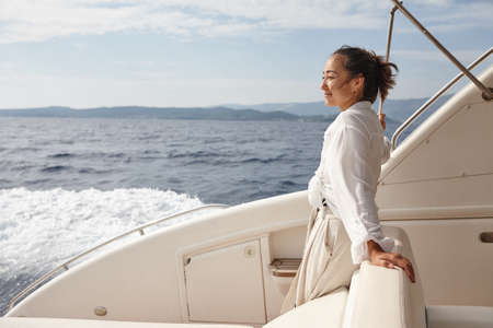 Woman on white yacht in the sea during summer vacation. Zakynthos, Greece.の写真素材