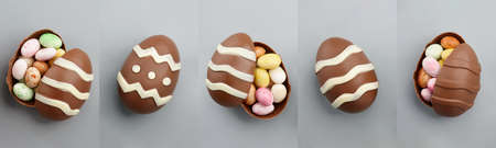 Collage with chocolate Easter eggs and colorful candies on gray backgroundの写真素材