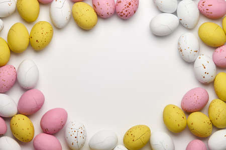 Colorful glazed chocolate eggs for Easter holiday on white background. Sweet candies.の写真素材