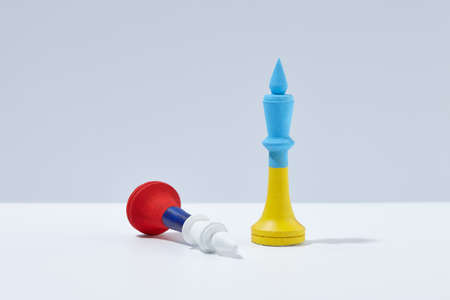 Ukrainian and Russian chess kings on white background. War in Ukraine.の写真素材