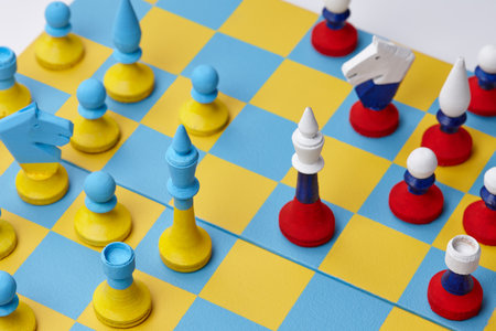 Ukrainian and Russian national colors chess sets on board. War in Ukraine.