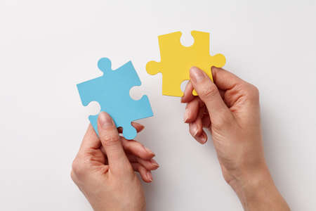 Ukrainian colors puzzle pieces in womans hands