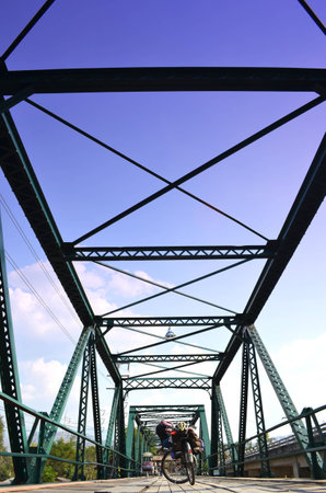 Bicycle on Historical Iron Bridge, Cloudy and Blue Sky, Maehong province, Thailand.の写真素材