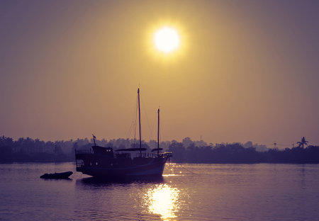 The wooden boat on river in the Sunriseの写真素材