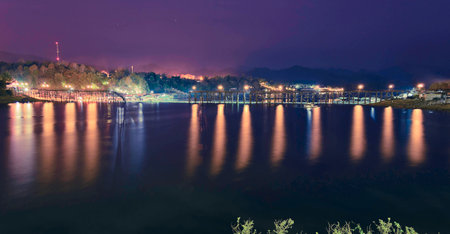 The calm lake on the dark night with lights の写真素材