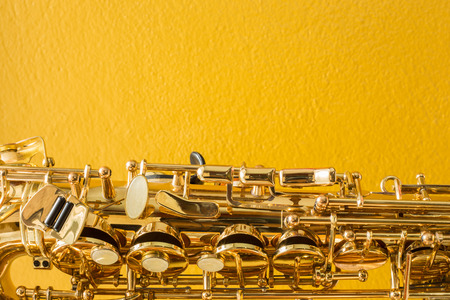 Saxophone on the yellow backgroundの写真素材