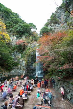 Osaka, Japan - November 27, 2015: Mino waterfall in Mino Quasi-national Park in Osaka, tourists enjoy to take photo with the waterfall in the autumn season.のeditorial素材