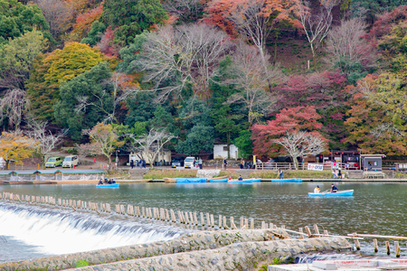 Arashiyama, Japan - December 2, 2015: Arashiyama is a tourist district in the western of Kyoto.  It is particularly popular during the cherry blossom and fall color seasons. Tourists can sail the boat for enjoying the forest and mountainsides along the riのeditorial素材