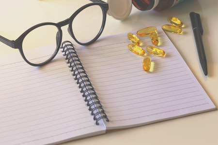 Notepad and Omega 3 capsule, business conceptの写真素材