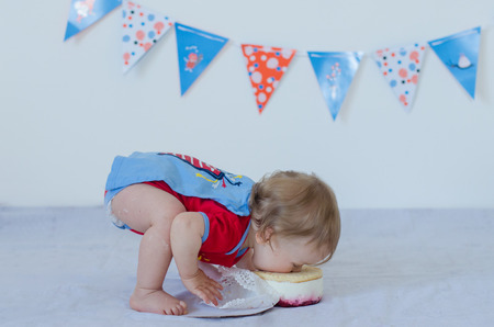 One year old baby eating cakeの写真素材