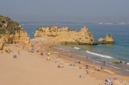 PORTUGAL - APRIL 2017: People on Praia Dona Ana beach in April 17, 2017, located in Lagos, Portugal. One of the best beaches in the Algarve region of southern Portugal.のeditorial素材