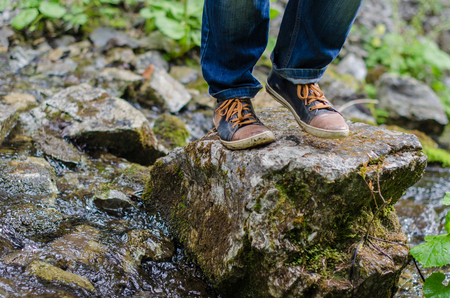 Adults feet walk along the mountain pathの写真素材