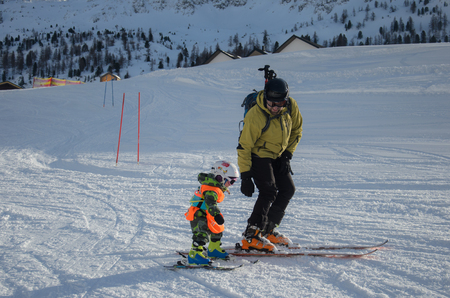 Stunning view of the mountains and skiers family in Obertauern ski resortの写真素材