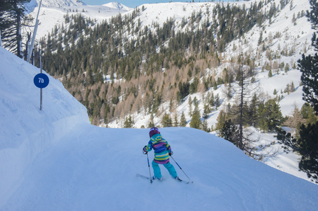 Stunning view of the mountains and child skier in Obertauern ski resortの写真素材