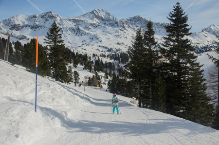 Stunning view of the mountains and child skier in Obertauern ski resortの写真素材