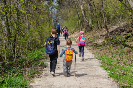 Children from their backs in the Normafa forestの写真素材