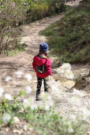 Family walk or hike on trail under chairlift in early spring, April on Buda hillsの写真素材