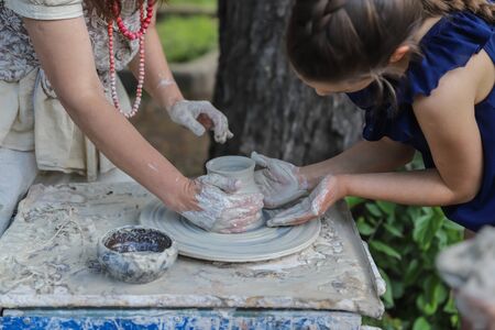Girl works on a potters wheel - master class for children and adultsの写真素材