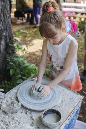 Girl works on a potters wheel - master class for childrenの写真素材