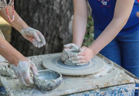 Hands on a potter's wheel - handicraft for children and adultsの写真素材