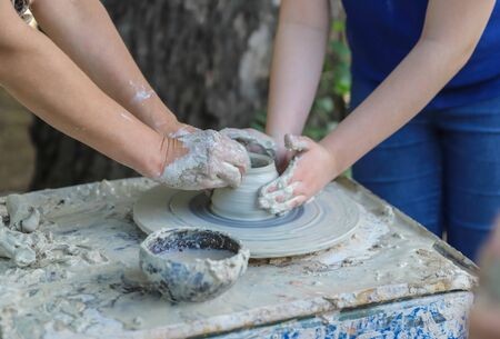 Lots of hands on a potters wheel - master class for children and adultsの写真素材