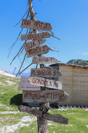 An old direction pointer on a hiking route in Vogel Ski Resortの写真素材