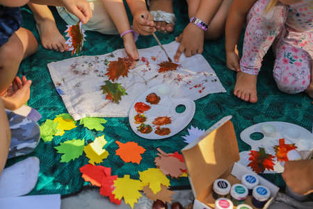 Childrens art and craft of leaves made from paper and paintsの写真素材