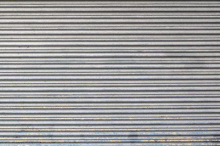 Gray color metal roller shutter door texture and background.