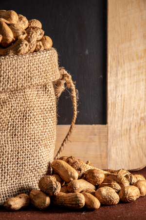 Sack bag with peanut on brown background.の写真素材